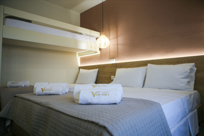 Close up of double bed with Verano towel